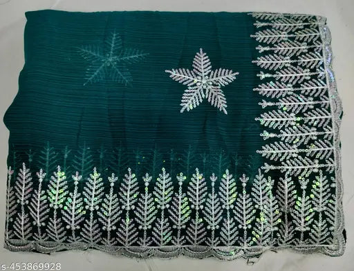 Black fabric with white sequin embroidery, green and silver sequin border, star decoration
