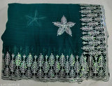 Black fabric with white sequin embroidery, green and silver sequin border, star decoration