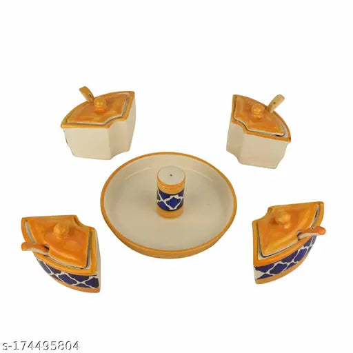 A set of four handpainted ceramic jars for serving pickles, each with a lid and spoon, accompanied by one salt dispenser on a tray. The jars have a yellow-blue pattern