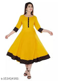 White Anarkali kurta with embroidered borders, tassels