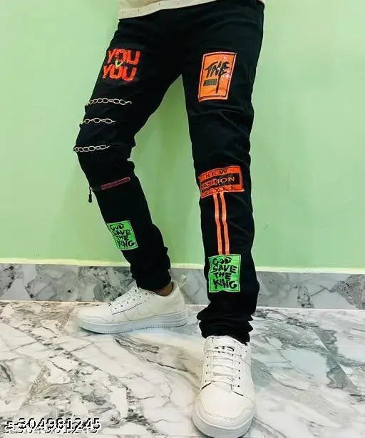 Fashionable men's black cotton blend jeans with slim fit, unique design, 3 chain on right side leg, and attachable stickers. Sizes: 24 (Waist: 24in, Length: 39in), India origin