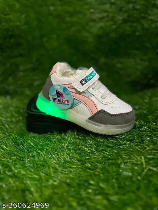 Neon green LED sneaker with black laces and a minty pastel color