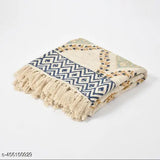 Multi-colored, multi-size, cotton throw or blanket with a fringed edge and patterned with a block print design