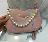 Stylish sling bag in marbled material, silver metal accents, pearl necklace design
