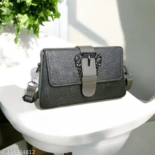 Chic sling bag, black leather with goldtone hardware, crossbody style