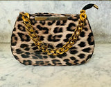 Leopard print sling bag with zip closure, designer label