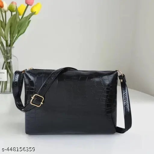 Stylish black leather shoulder bag with a gold-tone buckle