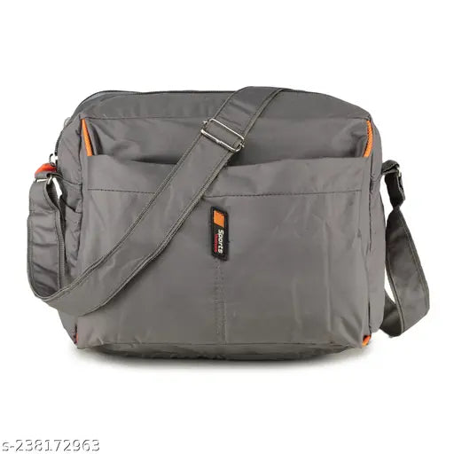 Grey fabric Guka sling bag with red accents, 4 zip pockets, adjustable strap
