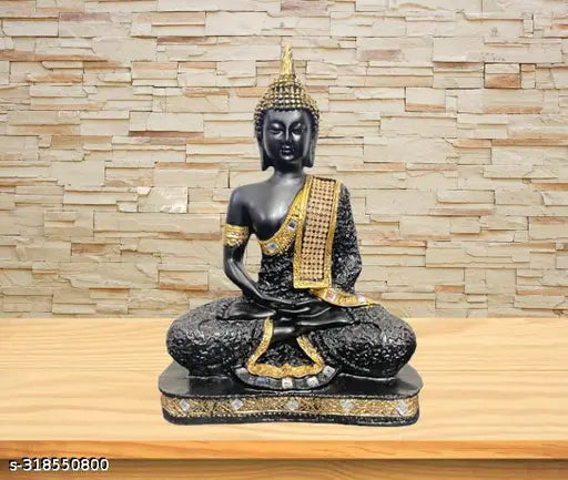 Black marble Buddha statue with gold inlay on plaque, sitting cross-legged