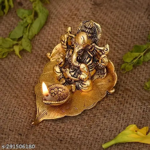 Metal Ganesh idol on pipal leaf diya set, Vastu-compliant for home, temple, office, and gifting. Symbolizing luck, love, happiness, and prosperity. Size: 9.5x10.5x6 cm