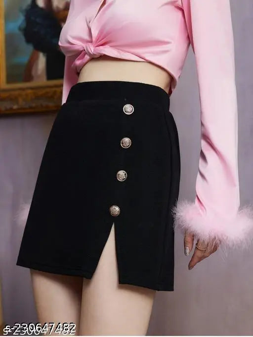 A woman in a pink off-the-shoulder top and high-waisted black shorts with buttons
