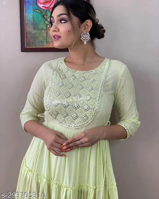 Light green cotton embroidered flared Anarkali gown, intricate mirror work and tassels, perfect for parties or special occasions