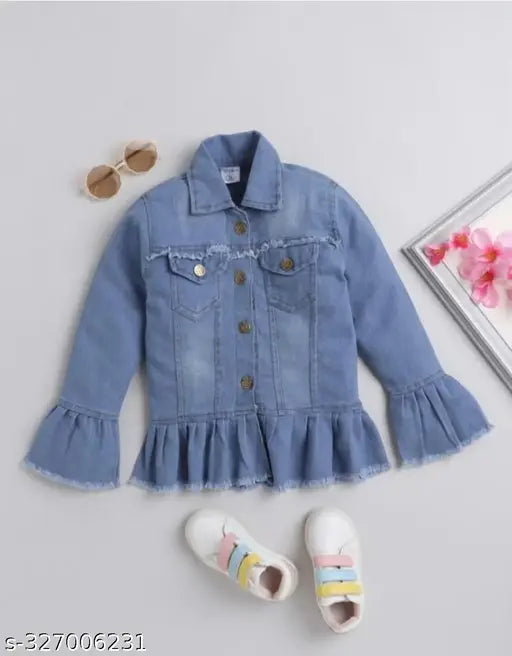 A pair of sunglasses with a frame resting on top, positioned beside a jean jacket with blue wash and ruffled edges