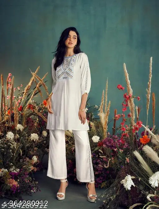 Autumn white rayon embroidered co-ord dress with three-quarter sleeves, shrug included. Indian hand-embellished women's co-ord set on display