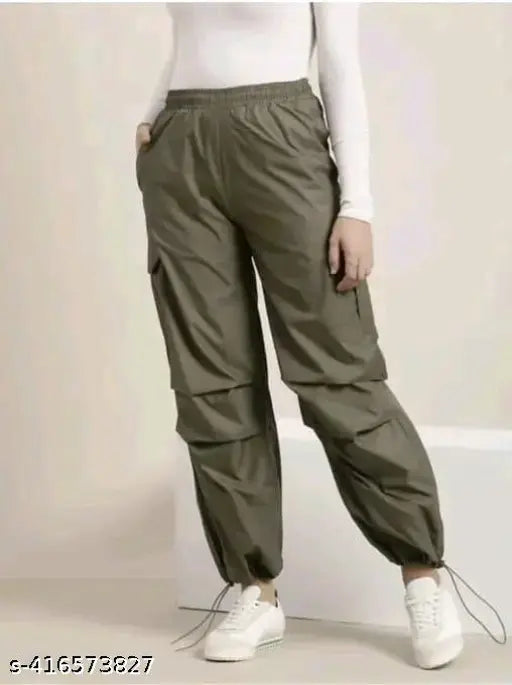Green cargo pants with pockets and drawstrings, cropped length