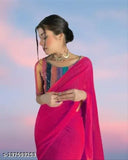 A woman in a pink sari with a dupatta over her shoulder, standing against a blue sky backdrop