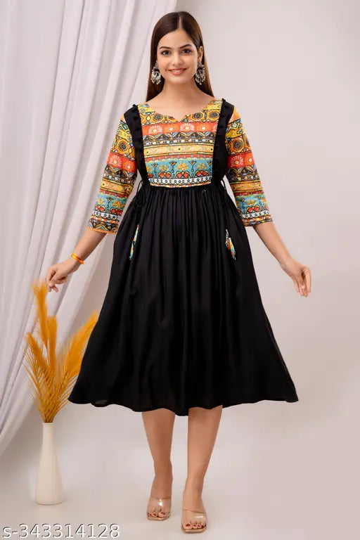 Black sleeveless midi dress with vibrant pattern, cinched waist and flared skirt