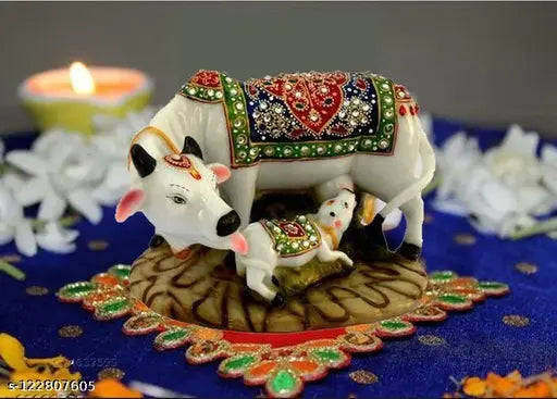 A multi-colored, stone-studded marble and polyresin cow and calf statue with a big size, part of a Vastu Nandi Pooja decorative showpiece