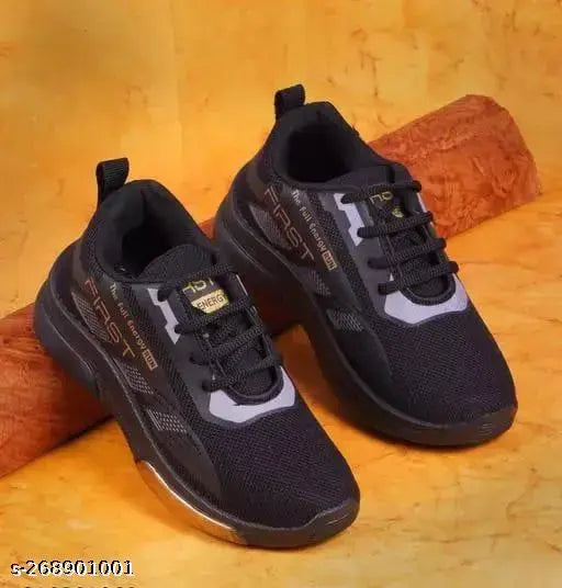 A pair of stylish and comfortable sports shoes for kids, featuring a black knit upper with white sole detailing, suitable for boys and girls