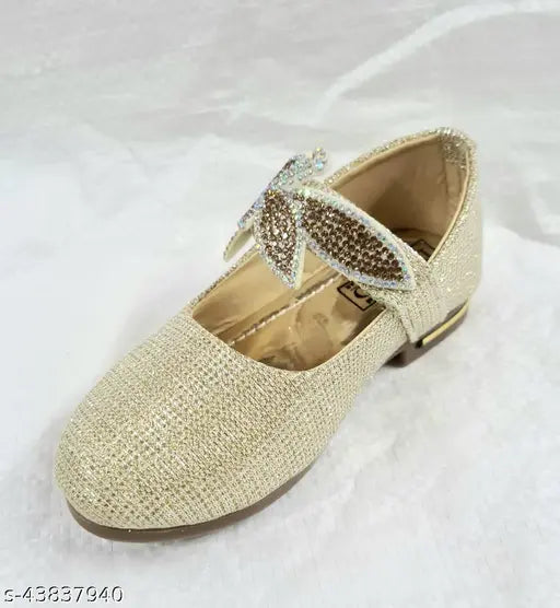 Gold mojari juttis with embellishments, possibly crystal accents