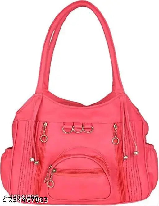 Pink leather handbag with a heart-shaped accent