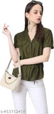 A woman wearing a casual olive green top stands against a plain background. She has short hair and is holding her hand on her hip. The sling bag in the image appears to be of an olive green hue, made from fabric with a fluffy texture resembling clouds. It features one main compartment and multiple smaller pockets, designed for travel essentials