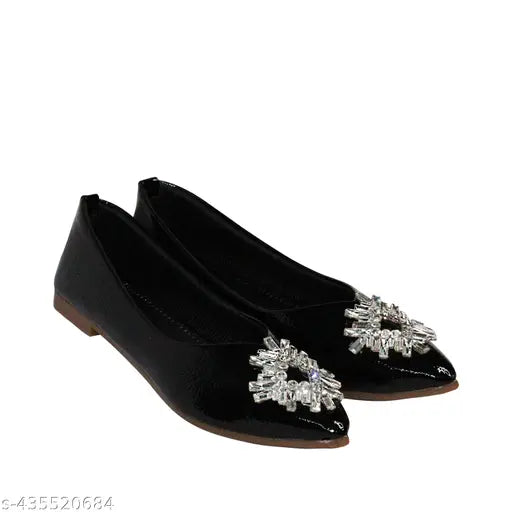 Black flat with a large embellished flower accent on the toe