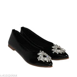 Black flat with a large embellished flower accent on the toe