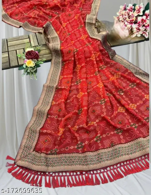 Red and gold traditional shobhagyawati sari with fringe details, displayed on a hanger