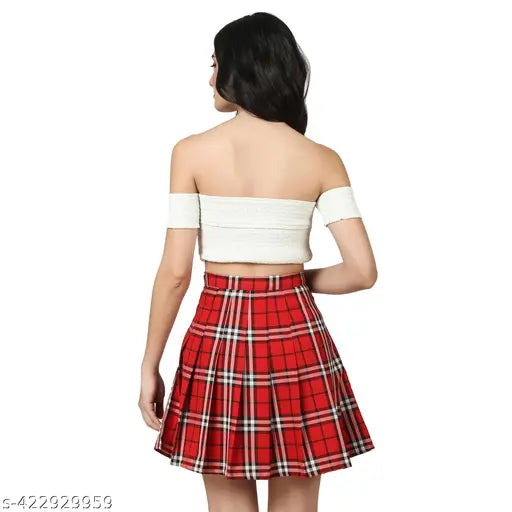 Red checked polyester mini tennis skirt with attached shorts, high-waist design, versatile for sports and casual wear, durable and comfortable, machine washable. Available sizes: 24/XS (Waist 24", Hip 32", Length 17.5"), 26/S (Waist 26", Hip 34", Length 17.5"), 28/M (Waist 28", Hip 36", Length 17.5"), 30/L (Waist 30", Hip 38", Length 17.5"), 32/XL (Waist 32", Hip 40", Length 17.5"), 34/2XL (Waist 34", Hip 42", Length 17.5"), 36/3XL (Waist 36", Hip 44", Length 18"). Made in India