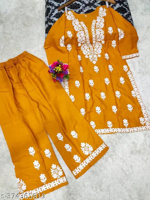 Rayon Chikankari straight kurta set with embroidered net pants, three-quarter sleeves. Indian rayon clothing on display