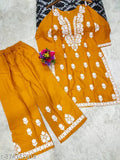 Rayon Chikankari straight kurta set with embroidered net pants, three-quarter sleeves. Indian rayon clothing on display