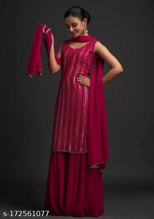 A long red and gold embroidered dress with a fitted bodice, sleeveless, and flared skirt