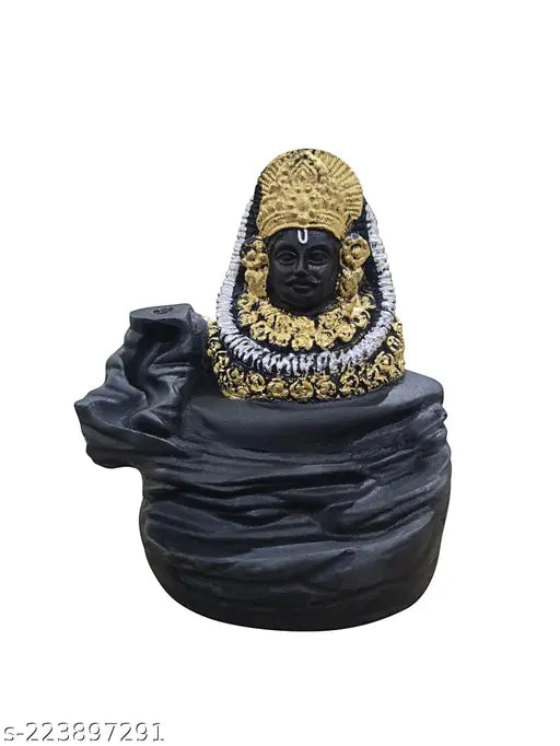 The image shows a decorative incense holder in the shape of the Hindu deity Shyam, with multiple cones placed around it. This smoke murti appears to be made of a dark material and has an intricate design, featuring what looks like gold details