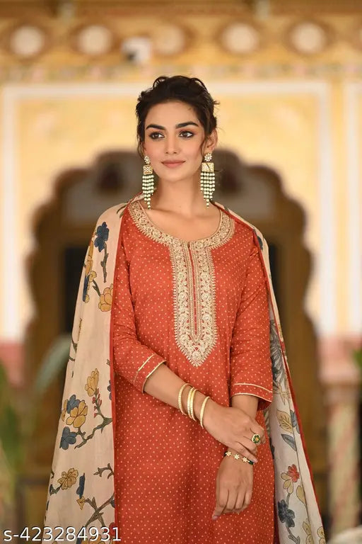 Red printed cotton blend straight kurta with palazzo and dupatta, solid-patterned women's fashion wear on mannequin from India