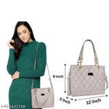 A slender, light pink handbag with a quilted pattern and two handles