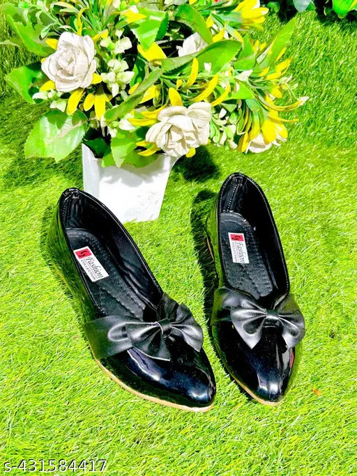 Black patent heels with a bow on the toe