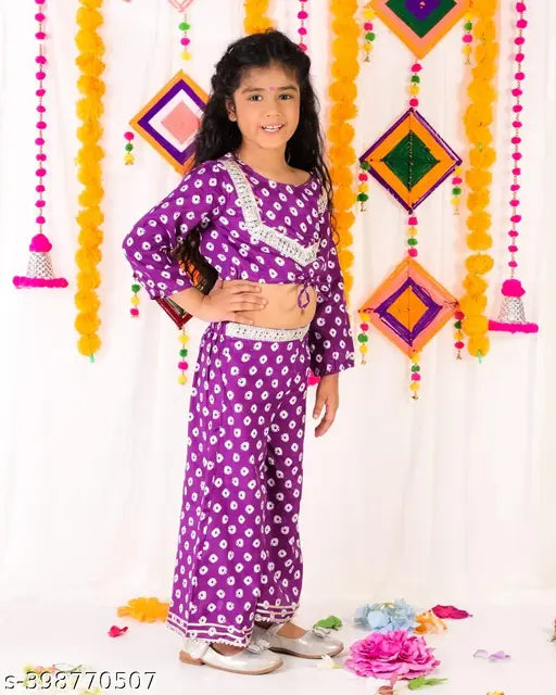 Purple bandhni crop top plazzo with kora muslin dupatta, premium quality pure muslin fabric and heavy gota detailing. Sizes: 6-12 months, 1-2 years, 2-3 years, 5-6 years, 6-7 years, 8-9 years. Indian traditional clothing for kids on display