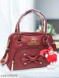Stylish red sling bag with adjustable straps, front pocket and bow detailing