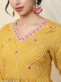 Mustard viscose rayon anarkali kurta with ethnic motifs, flared style and three-quarter sleeves on a woman