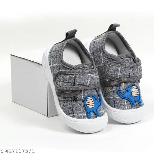 Soft velcro slip-on shoes with anti-slip soles, suitable for unisex children aged from 3 months to 25 years. Grey with blue velcro straps and a small chu chu sound logo on the heel. Musical shoes with a unique design for kids' first walking experience