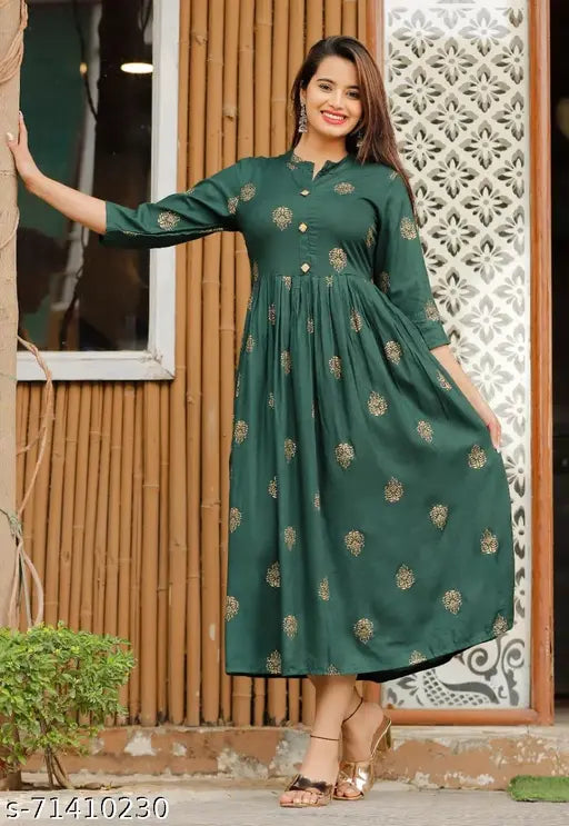 A woman in a green rayon printed anarkali kurta with short sleeves and a round neckline