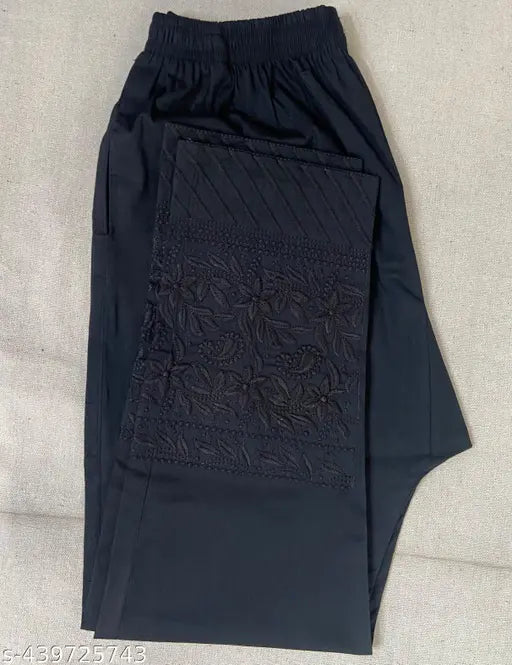 Black Lucknowi Cotton Lycra trouser for women with embroidered net and side pockets. Indian-made chikankari pants on mannequin
