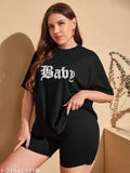 Women's oversized black t-shirt with white 'BABY' text on front, short sleeves