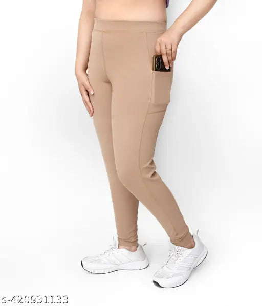 Trendy beige polyester pocket jeggings for women, high-waisted and stretchy for everyday comfort