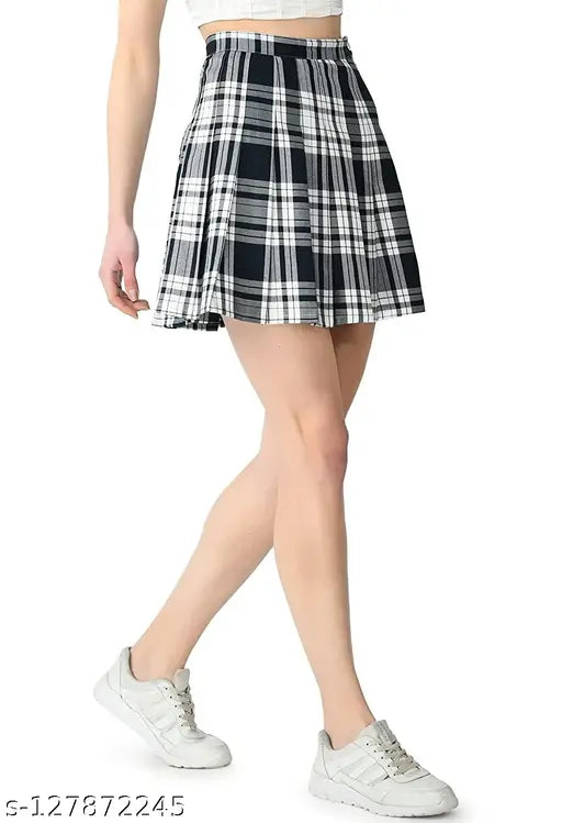 A woman wearing a short pleated skirt. The skirt is black and white checkered patterned, with a high waistband
