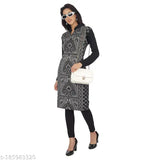 A woman wearing a black paisley patterned kameez with an embellished collar and cuffs. The attire features long sleeves, a flared skirt, and is complemented by black leggings and heels
