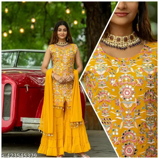Women's traditional Indian outfit set, including a long yellow skirt with fringe details and embellished blouse, perfect for celebrating Navaratri festivals