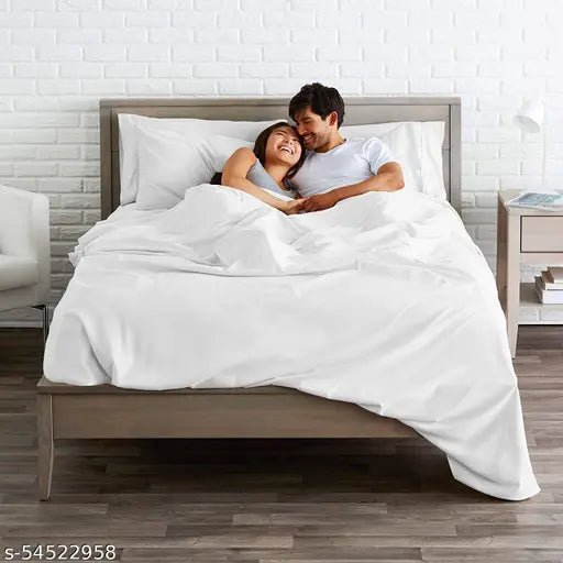 White cotton sateen bedsheet with pillow cover on a wooden bed frame. s5452958