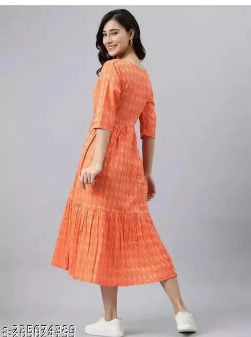 Woman in an orange anarkali dress with ruffled sleeves and calf-length skirt